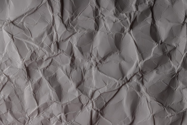 しわくちゃの紙。灰白色の紙のシート。詳細な高解像度テクスチャ。壁紙の抽象的な背景。
