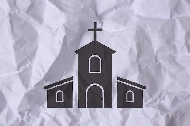 Crumpled paper with illustration of church as background top view