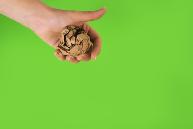 Crumpled papers in the hand on white background. zero waste concept. replacement for plastic cups