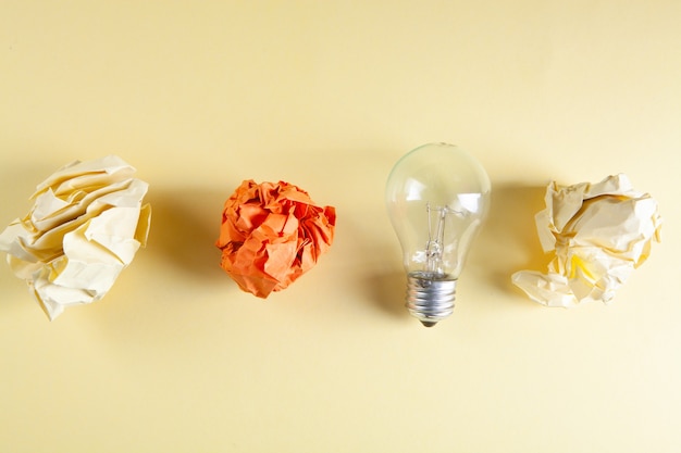 Crumpled papers and a light bulb on the table