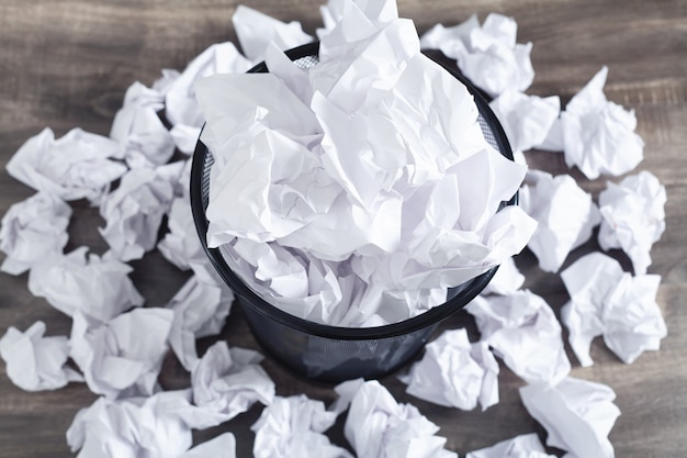 Crumpled papers in the trash can.