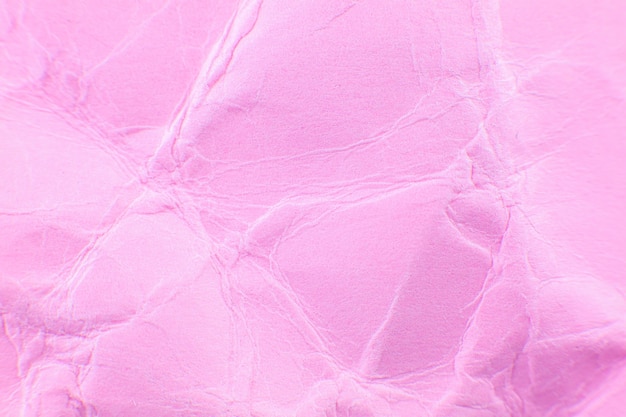 Photo crumpled pink paper background. real macro battered texture. close up photo.