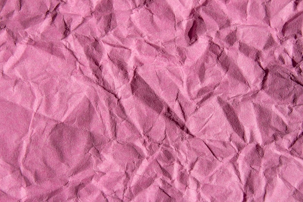 Crumpled pink paper texture background photo