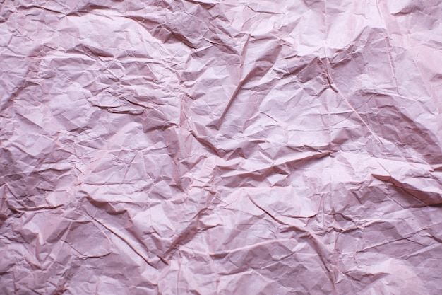 Crumpled pink paper texture background