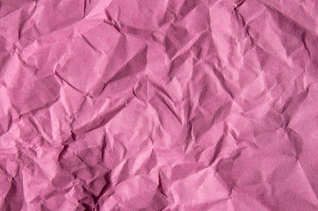 Crumpled pink paper texture background