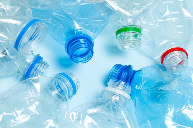 Crumpled plastic bottles on a blue background. Plastic trash.