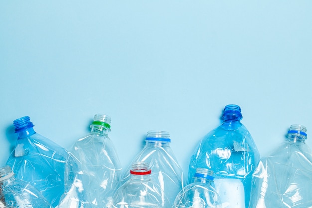 Crumpled plastic bottles on a blue background. Plastic trash.