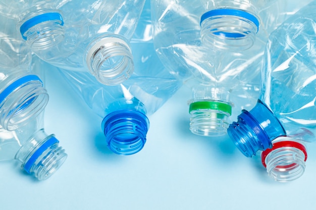 Crumpled plastic bottles on a blue background. Plastic trash.