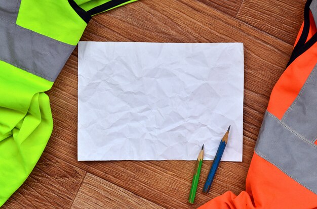 A crumpled sheet of paper with two pencils