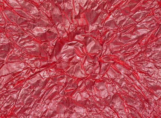 Crumpled sheet of red foil full frame