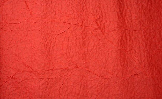 Crumpled sheet of red paper, creases and scuffs. Place for inscription, full frame