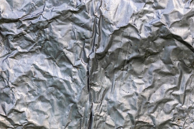 Photo crumpled thick aluminium foil wall insulation surface texture and background