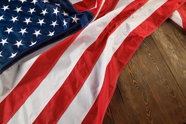 Crumpled usa flag on flat textured wooden surface background