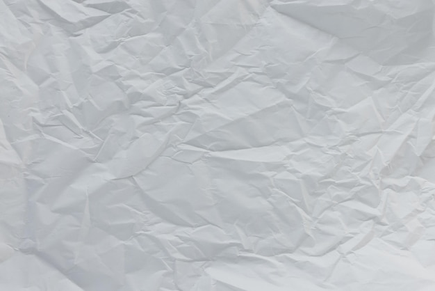 Crumpled used white wrapping paper texture background