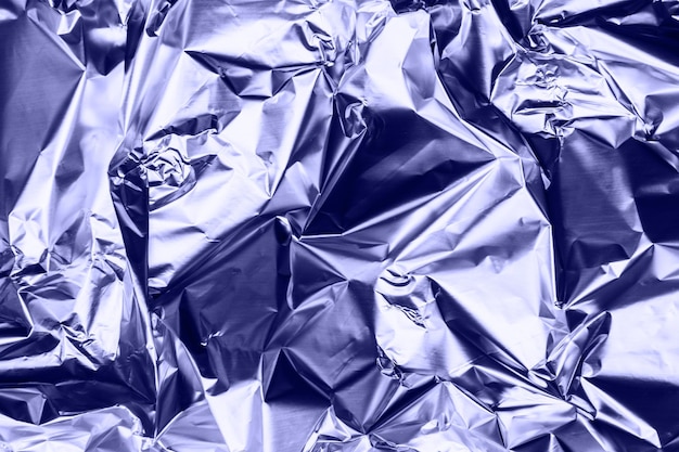 Crumpled very peri or violet foil background abstract pattern