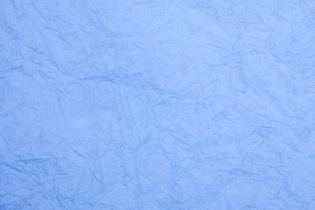 Crumpled vintage blue paper textured obsolete background.