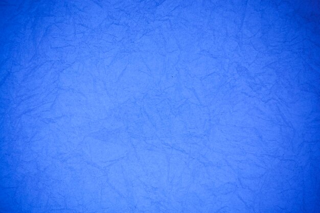 Crumpled vintage blue paper textured obsolete background.