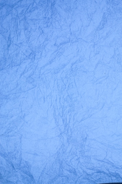 Crumpled vintage blue paper textured obsolete background.