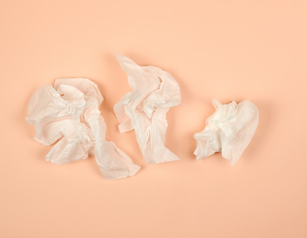 Crumpled white paper napkins on beige