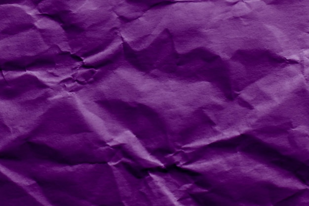 Crumpled or wrinkled purple violet paper texture background