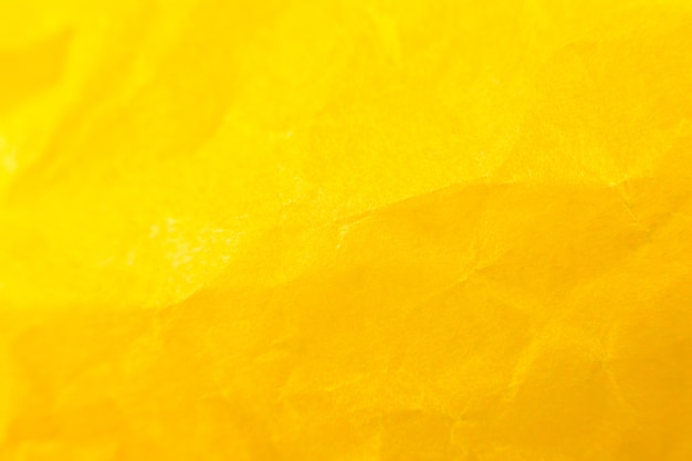 Crumpled yellow paper background. real macro battered texture. close up photo