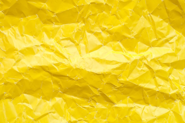 Crumpled yellow paper texture. Yellow background