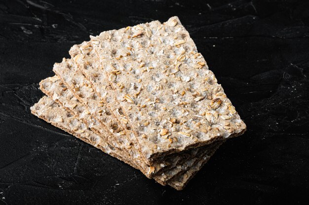 Crunchy crispbread Healthy snack set, on black dark stone table