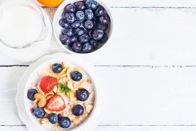 crunchy flakes with blueberries and various yogurts for healthy breakfast, close-up