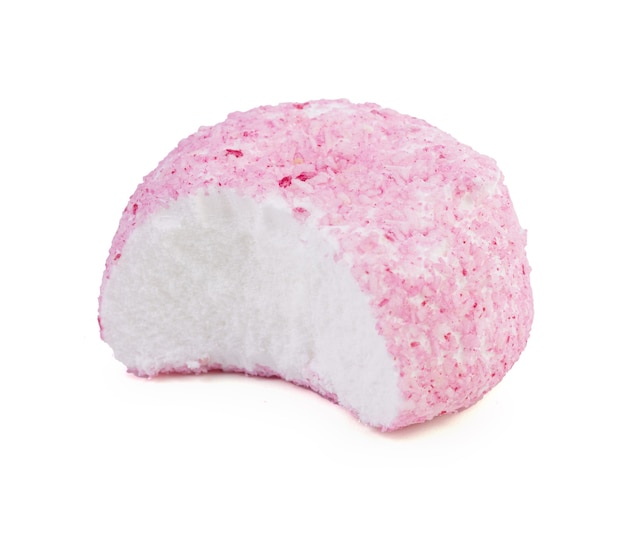 Crunchy pink coconut ball candy on white surface