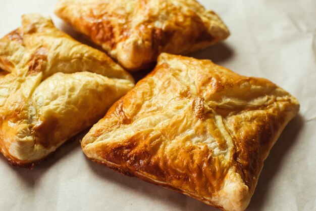 Crunchy puff pastry pies, homemade baking, top view. Freshly baked.