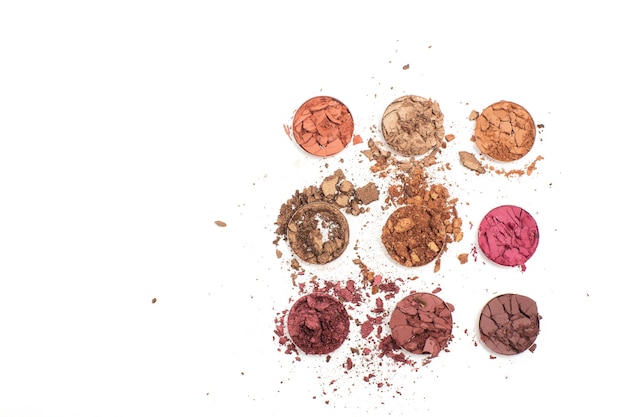 Crushed eye shadow set as a sample of makeup product against white background. Space for text