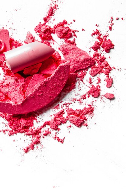 Crushed eyeshadows lipstick and powder isolated on white background