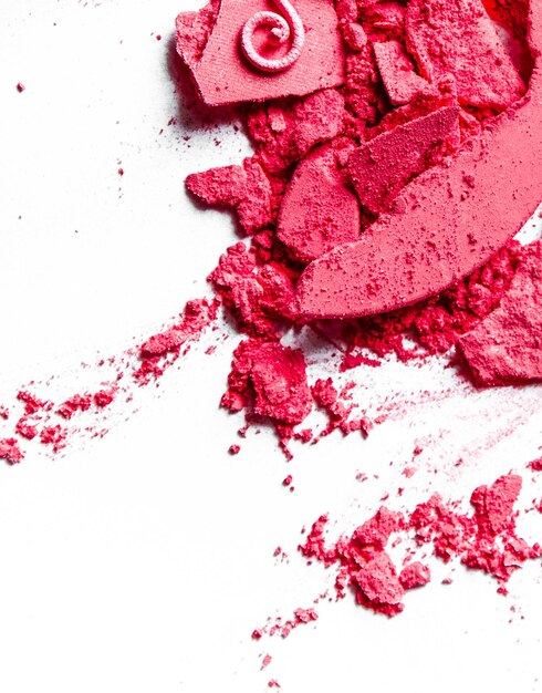 Crushed eyeshadows lipstick and powder isolated on white background