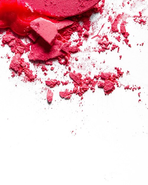 Crushed eyeshadows lipstick and powder isolated on white background