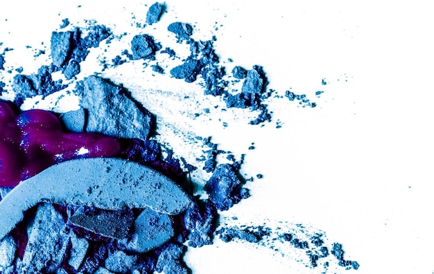 crushed eyeshadows lipstick and powder isolated on white background