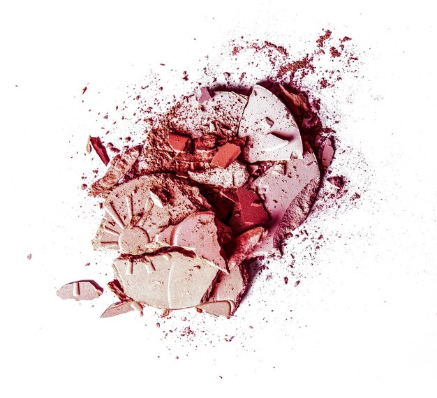 Crushed eyeshadows and powder isolated on white background