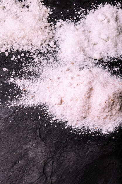 Crushed pink Himalayan salt on slate background