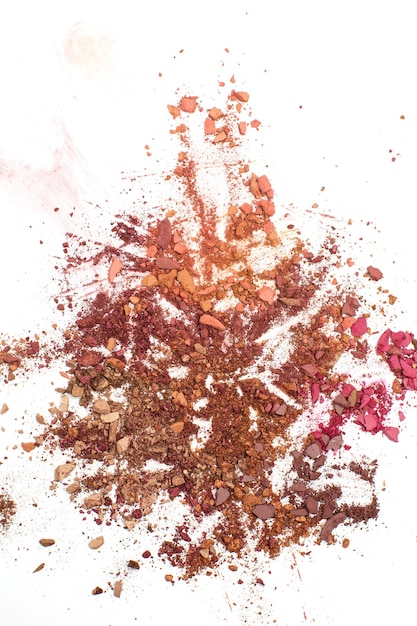 Crushed red and brown samples of eye shadows. Space for text