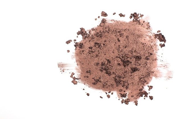 Photo crushed texture of dark brown eye shadow on a white background. space for text