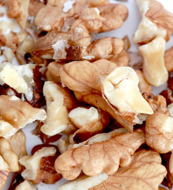 crushed walnuts on white backgroundimage of a