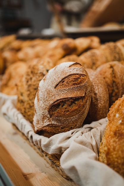 Crusty bread with flour on it in a rustic basket in a bakery