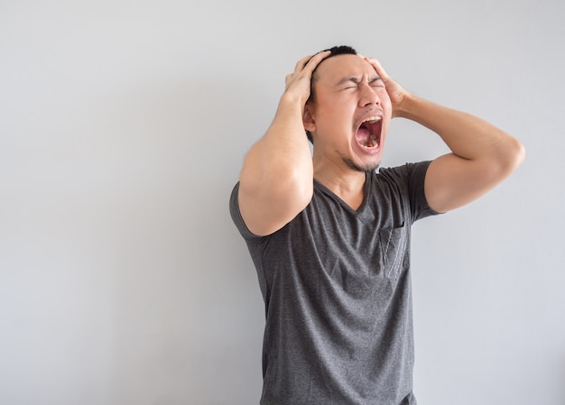 Crying asian man in black t-shirt.