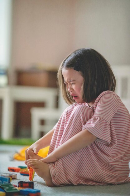 Photo crying girl sitting at home