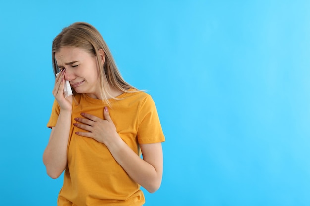 Crying girl in t-shirt on blue background