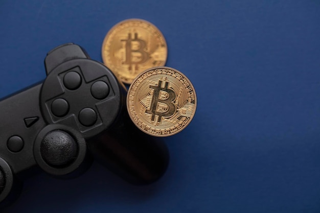 Crypto gaming concept video game controller with a bitcoin\
cryptocurrency coin