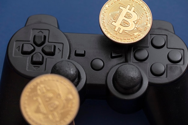 Crypto gaming concept video game controller with a bitcoin\
cryptocurrency coin