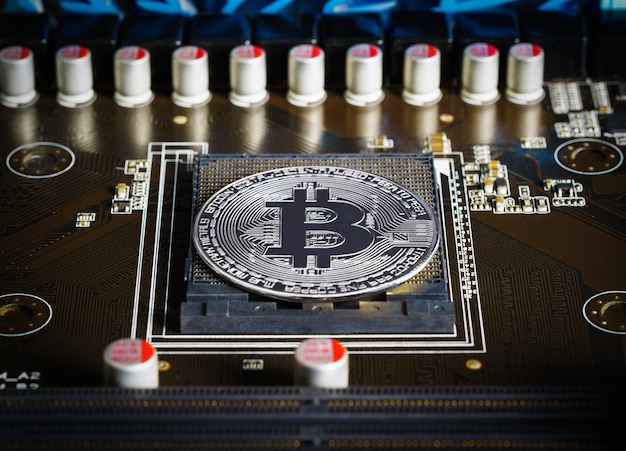 Cryptocurrency bitcoin silver coins on circuit board