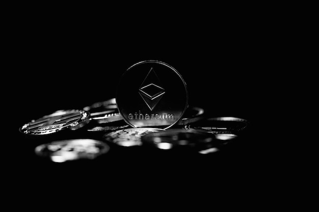 Cryptocurrency coin on black background. The world crisis. Electronic currency.