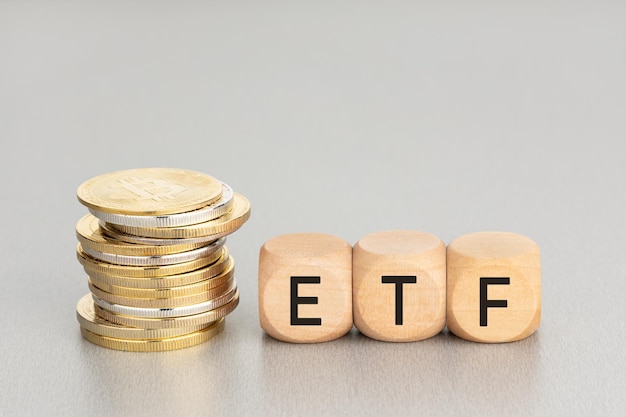 Cryptocurrency ETF concept Stacked crypto coins and wooden blocks with text Copy space