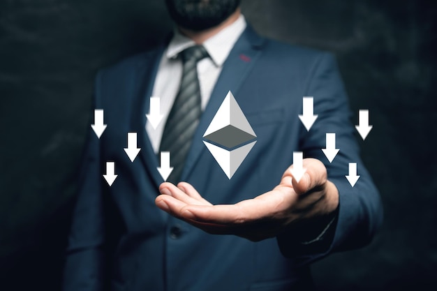Cryptocurrency icon with down arrows Man holding in his hand